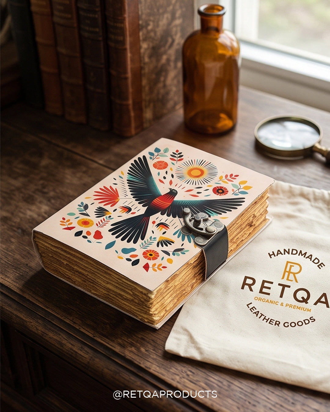 Handcrafted leather journal featuring folk bird and radiant sun art, deckle-edge paper, and an antique latch.